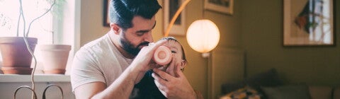 Dad bottle feeding his baby